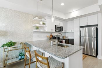 A kitchen with stainless steel appliances and granite counter tops